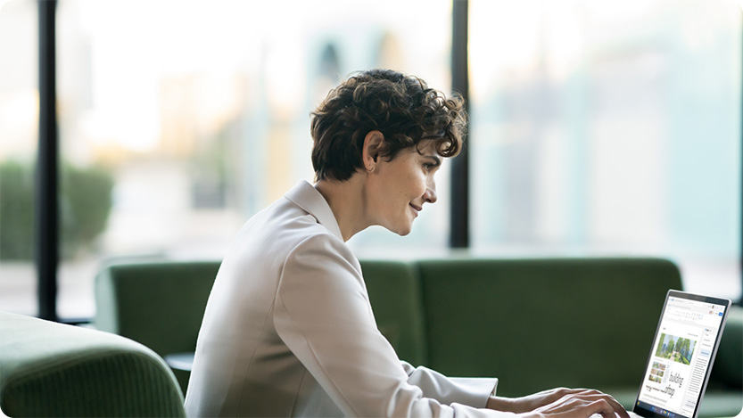 Person sitting at a desk using a laptop.